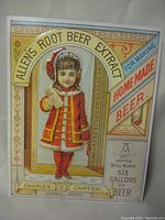 Front view of the metal sign showing colorful advertisement with a girl in red coat holding a bottle and ornate border.