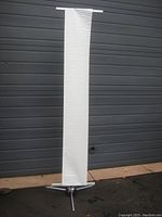 Front view of assembled banner stand with base and banner visible, showing height and attached banner material.