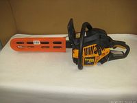 Side view of Poulan PRO PP4218A 42cc chainsaw with orange protective cover on bar.