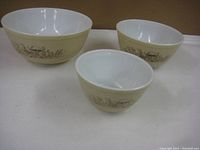 Set of three Pyrex nesting bowls in the Forest Fancies pattern, showing exterior design and size difference.