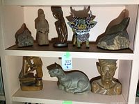 Overview of eight assorted items on white shelving