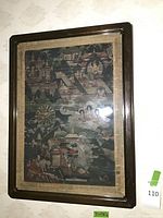 Full view of framed Asian fabric art print under glass in wood frame
