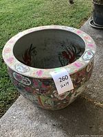 Front view capturing the wide round rim, inside view shows plain interior with some painted greenery accents.