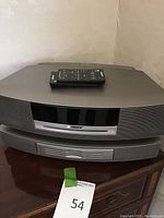 Front view of stacked Wave Music System main unit and 6-disc changer with one remote on top