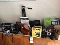 Overview of assorted cameras, Polaroid box, tripod, digital frame box