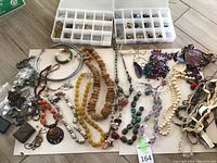 Overview of entire jewelry spread showing boxes, necklaces and bracelets