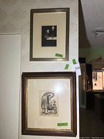 Overall view of two framed prints displayed on wall