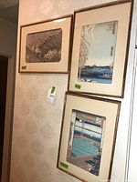 Three framed Japanese art prints displayed on wallpapered wall