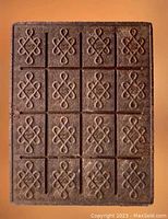 Front face showing 4x4 grid of knot motifs