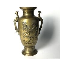 Front angle of antique bronze vase showing detailed bird handles and floral bird design.