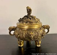 Front view of censer with lid, showing dragon relief on body and feet