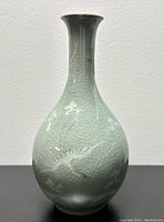 Full front view of vase on black surface against white wall