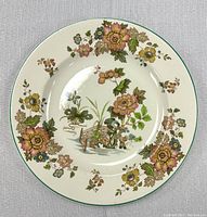 Top-down view of the Wedgewood Eastern Flowers plate showing the overall floral design and central bench scene