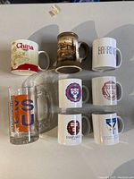 Novelty mugs including China, Barrington, vintage European scene, and university logos from Princeton, Harvard, Yale, and Syracuse