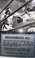 Close-up photo of the plaque showing the fight scene between Muhammad Ali and Sonny Liston and the descriptive text plate with edition number.