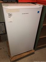 Front view of white Hamilton Beach bar fridge with branding and attached MaxSold label.