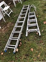 Photo showing both ladders laid flat on grass, 10-foot extension ladder on left, 5-foot step ladder on right.