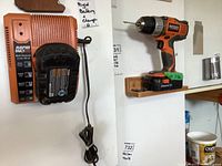 Rigid cordless drill with battery attached mounted on wall.