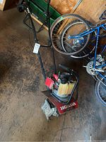 Full view of Honda FG100 rotary tiller showing handle, engine, fuel tank and tines