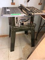 Full front view of Makita table saw with control panel and legs visible.