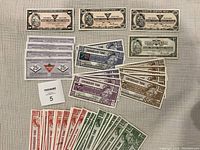 Photo showing all the bills neatly laid out by denomination on a flat surface.