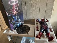 Original box upright next to styrofoam trays containing statue and base