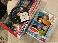 Photo showing sealed Interactive Dashboard with steering wheel and the First Play Zig Zag Tower box with animal blocks visible