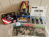 Shows assortment of Star Wars and Star Trek lunch boxes, Star Trek figures, and Star Trek records with cover art.