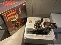 Box packaging showing the limited edition Marvel Thanos statue by Art Asylum, foam insert with statue parts, certificate visible.