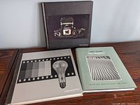 Overview photo of all three hardcover photography books: The Camera, Light and Film, Ansel Adams The Negative
