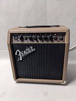 Front view of amplifier showing tolex covering, grille cloth, control panel, and Fender logo