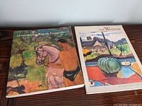 Two art books on a wooden surface: Masterpieces from the Guggenheim and The Window.