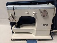 Front-right view of Elna SU sewing machine in open carrying case
