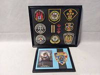 Full view of two framed collections; one with multiple Ontario police patches and insignias, the other with NYC Police badge patch and photo.
