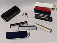 All 8 record cleaning tools including brushes, cases, and cleaning papers arranged on a flat surface.