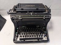 Front view of the Underwood typewriter showing keyboard layout and paper holder.