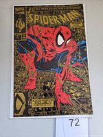 Front cover photo showing the gold foil Spider-Man comic book cover.