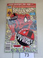 Front view of bagged Spider-Man #1 comic book showing cover art with Spider-Man and large collector's item stickers.