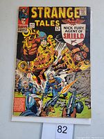 Front cover of Strange Tales #142 comic book showing Nick Fury and other characters in action scene with 12 cent price and Marvel Comics logo