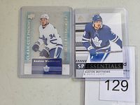 Front of two hockey cards featuring Auston Matthews in Toronto Maple Leafs uniforms.