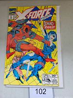 Front cover of X-Force #11 Marvel comic book with Deadpool and Domino characters, yellow background and comic title.