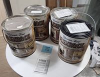 Four 1 gallon cans of Beauti-tone Flexrock wall and ceiling texture with labels showing use on walls and ceiling with textured finish.