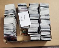 Box containing multiple stacks of basketball cards arranged neatly for sale