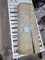 Carpet runner rolled up showing pattern and size tag