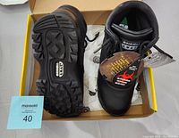 Pair of black original S.W.A.T. waterproof boots in size 7 inside the box showing slip-resistant soles and front view with original tags.