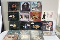 Front view of all 18 CD boxsets stacked showing various artists and titles, all sealed in plastic wrapping.