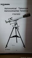 Front page of user manual showing Solomark astronomical telescope model F70070EQ with 70mm aperture and mounted on tripod.