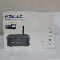 Front of the sealed AZULLE Byte Plus box showing branding, fanless Windows 10 mini desktop PC image, Intel Atom inside logo, and icons indicating email, watch, play, explore, and connect features.