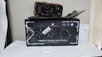 Thermalright Frozen Prism 240 black CPU liquid cooler box with RX580 video card on top.