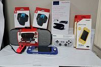 Full assortment of Nintendo Switch accessories with four black Oculus Quest 2 cases stacked at right